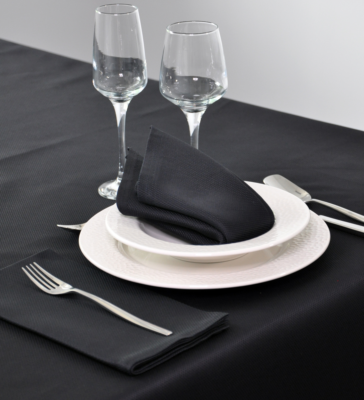 Close up texture of high quality white hotel linen sheets with detailed embroidery